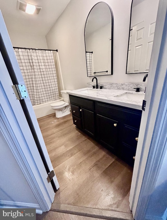 full bathroom featuring shower / tub combo, vanity, toilet, and hardwood / wood-style floors