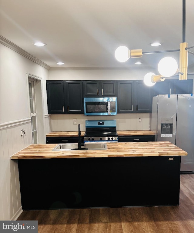 kitchen featuring sink, crown molding, wooden counters, stainless steel appliances, and dark hardwood / wood-style flooring