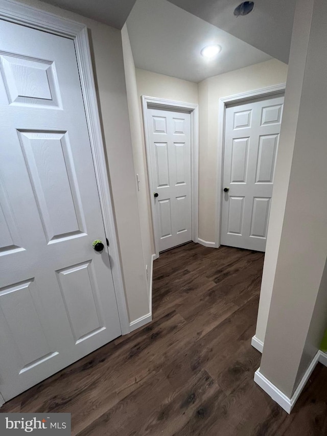 corridor with dark hardwood / wood-style floors