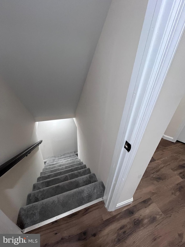 staircase featuring hardwood / wood-style flooring