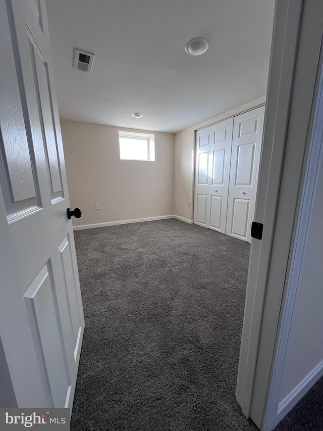 unfurnished bedroom featuring dark carpet