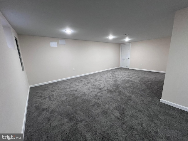 basement featuring dark colored carpet