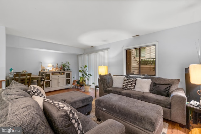 living room featuring visible vents and light wood finished floors