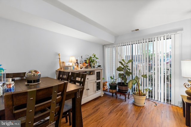 dining area featuring visible vents and wood finished floors