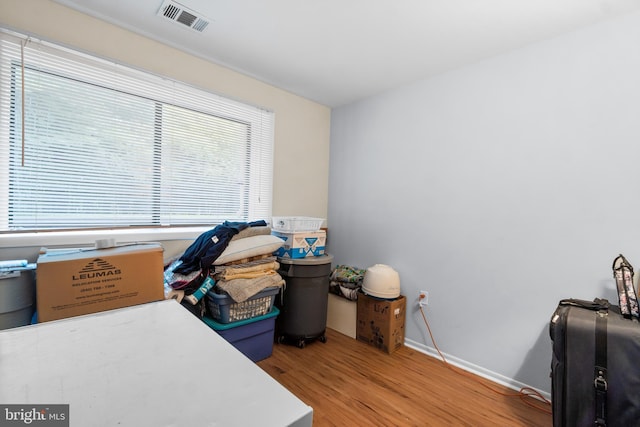 office space featuring light wood-type flooring, baseboards, and visible vents