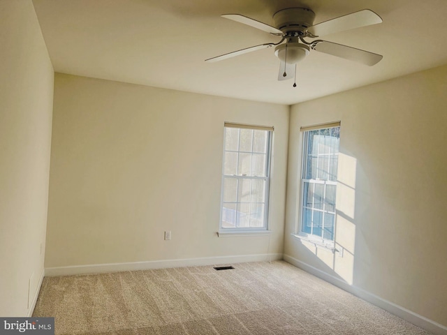 spare room featuring ceiling fan and carpet floors