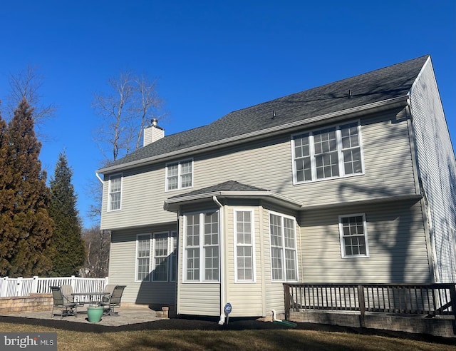 rear view of property with a yard and a patio area