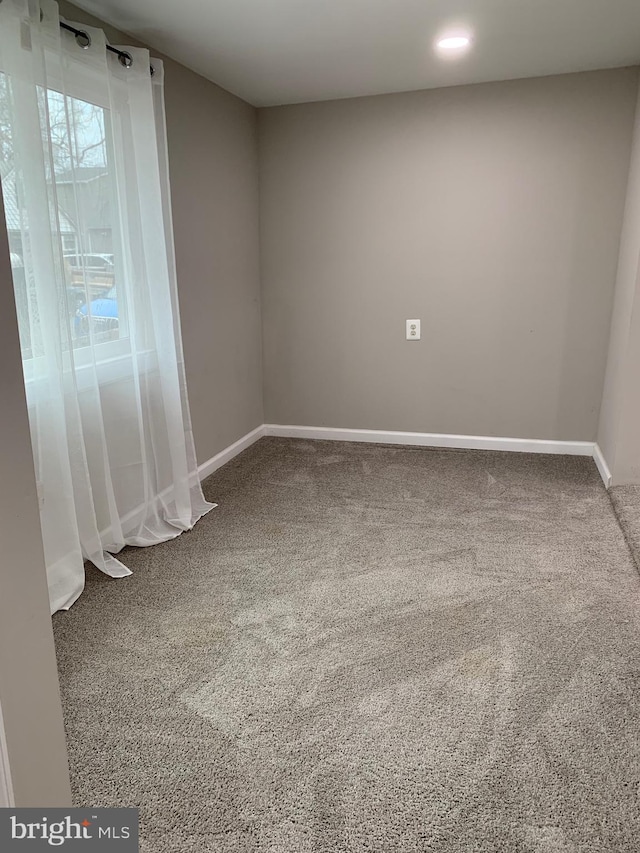 spare room with carpet flooring and baseboards