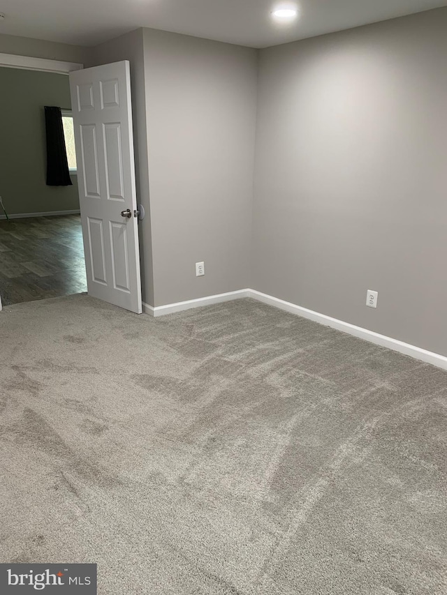 carpeted empty room with baseboards