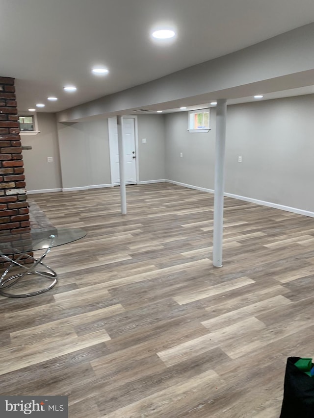 below grade area with baseboards, wood finished floors, and recessed lighting