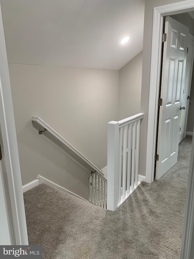 stairway with carpet and baseboards