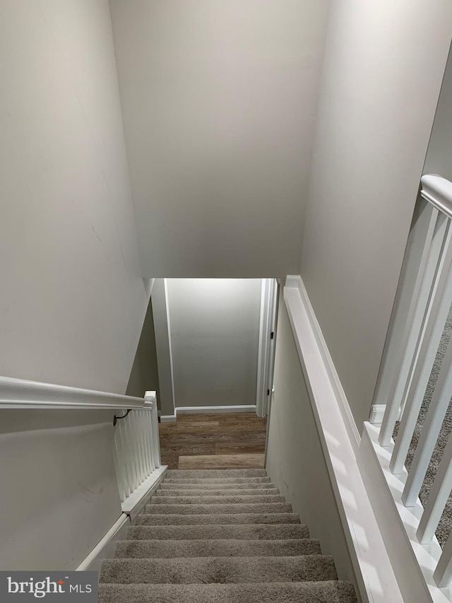 staircase featuring baseboards