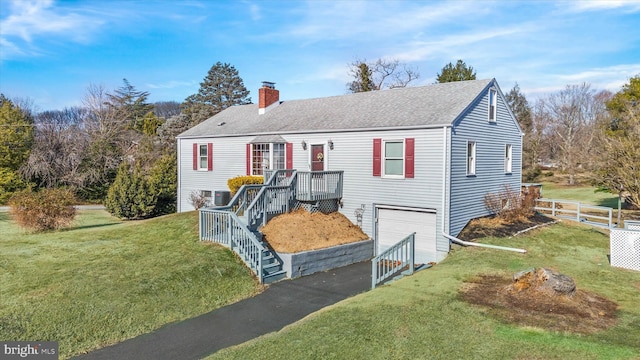 view of front facade featuring a deck, a front yard, and a garage