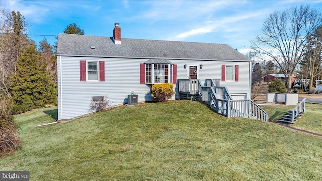 back of house featuring a lawn and central AC