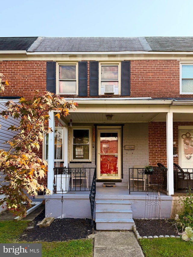 multi unit property featuring a porch and cooling unit