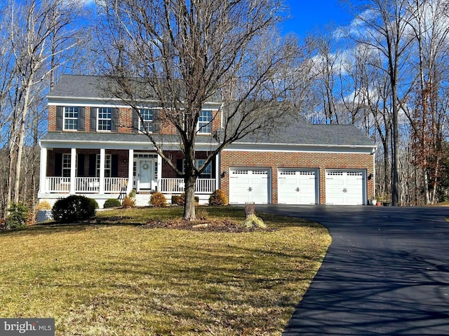 view of front facade with a front lawn, a porch, and a garage