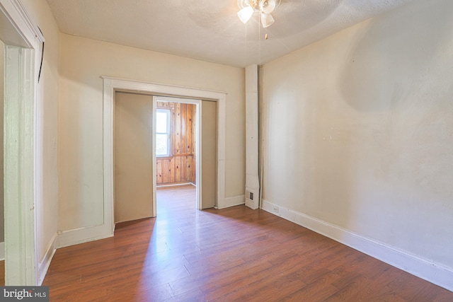 empty room with hardwood / wood-style floors and a textured ceiling