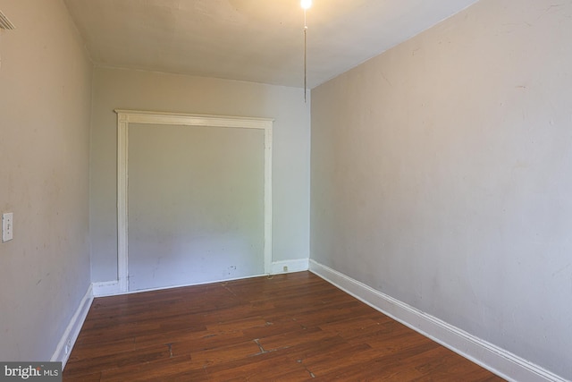 unfurnished room featuring dark wood-type flooring