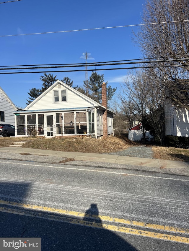 view of front of house featuring a sunroom