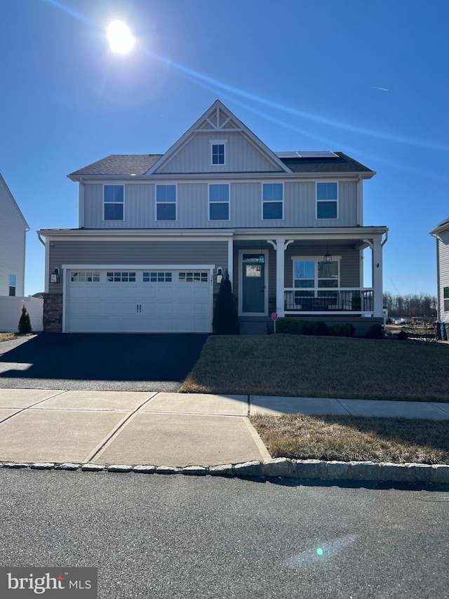 view of front of property with a garage and a porch