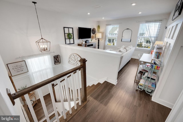 living room with dark hardwood / wood-style flooring and a notable chandelier