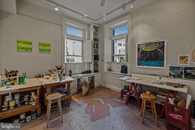 home office featuring hardwood / wood-style floors and a workshop area