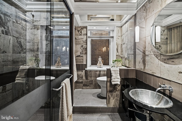 full bathroom with tile patterned flooring, a sink, tile walls, and toilet