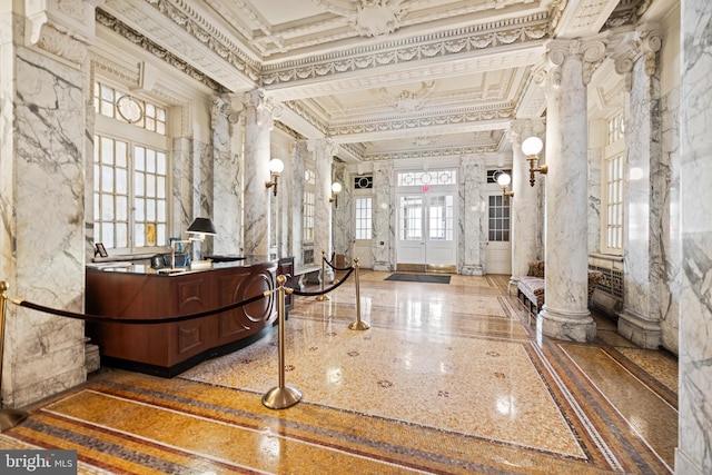 welcome area with ornate columns and french doors