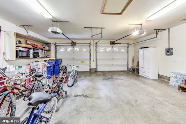 garage with electric panel and a garage door opener