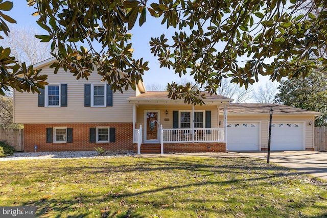 tri-level home with brick siding, covered porch, an attached garage, driveway, and a front lawn