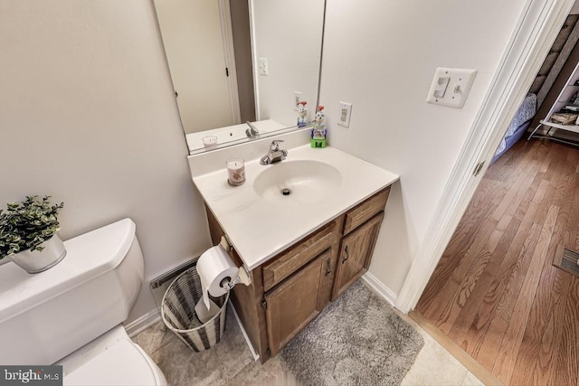 bathroom featuring toilet and vanity