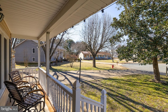 balcony featuring a porch and a residential view