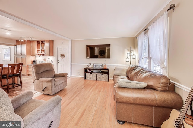 living area with light wood finished floors and baseboards