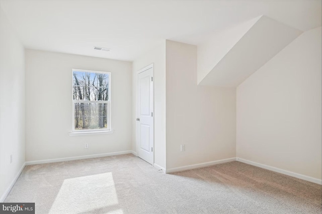 bonus room with light colored carpet