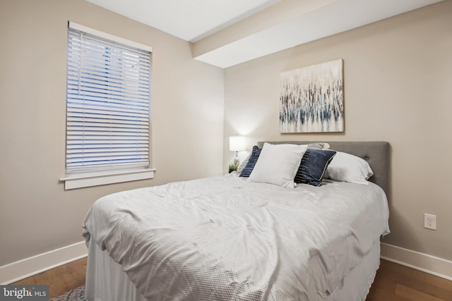 bedroom with dark wood-type flooring