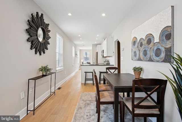 dining area featuring light wood-type flooring