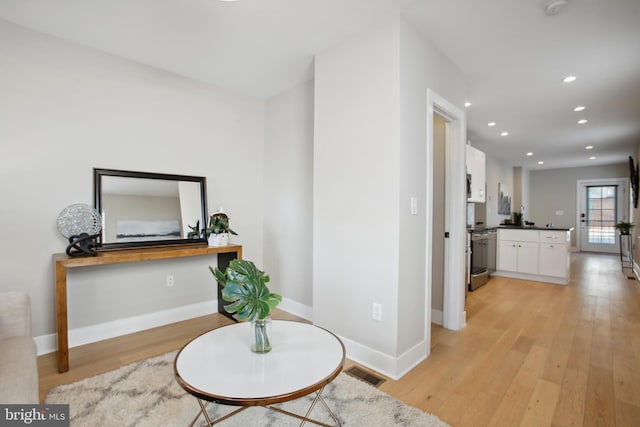 corridor with light hardwood / wood-style flooring