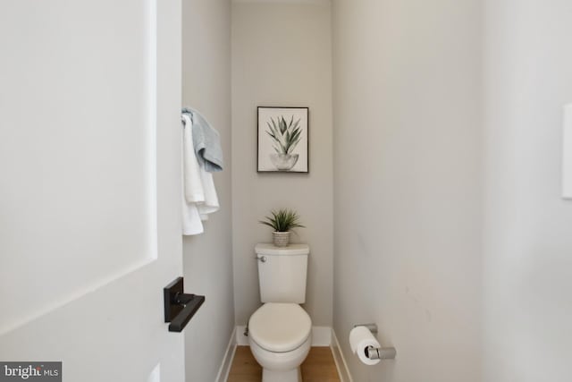 bathroom featuring wood-type flooring and toilet