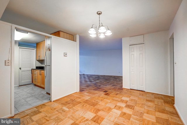 interior space with light parquet floors and a chandelier