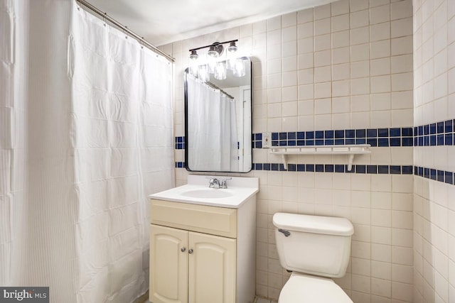 bathroom with vanity, tile walls, curtained shower, and toilet