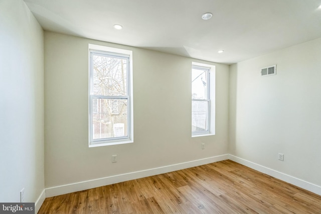 unfurnished room featuring a healthy amount of sunlight and light wood-type flooring