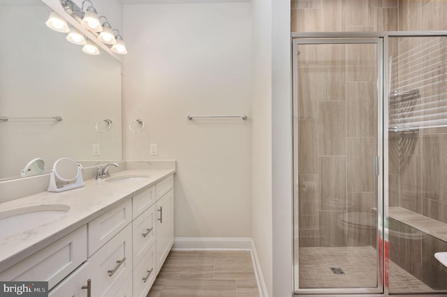 bathroom featuring vanity and a shower with shower door