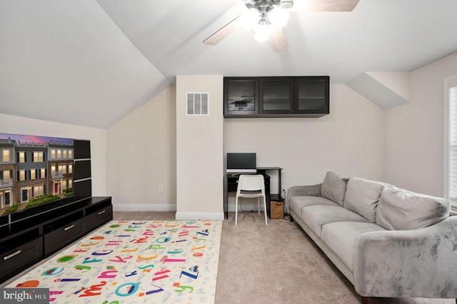 living room featuring ceiling fan, light colored carpet, and lofted ceiling