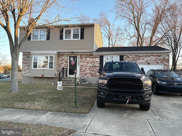 view of front of property featuring a garage and a front lawn