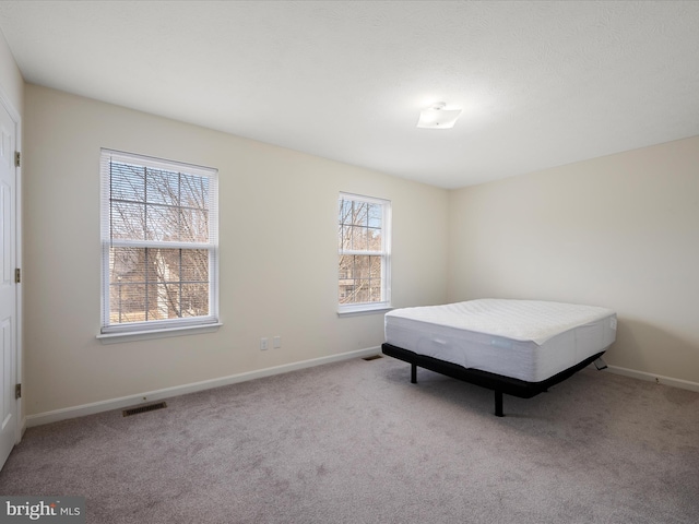 bedroom with light colored carpet