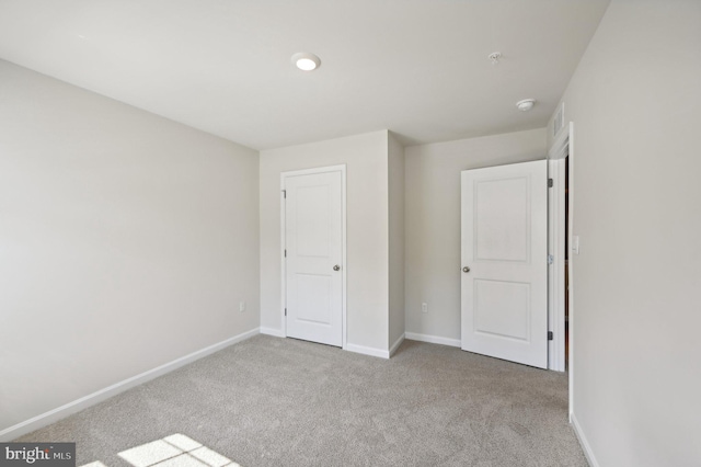 unfurnished bedroom featuring light colored carpet