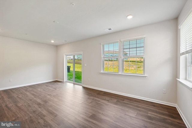 empty room with dark hardwood / wood-style flooring