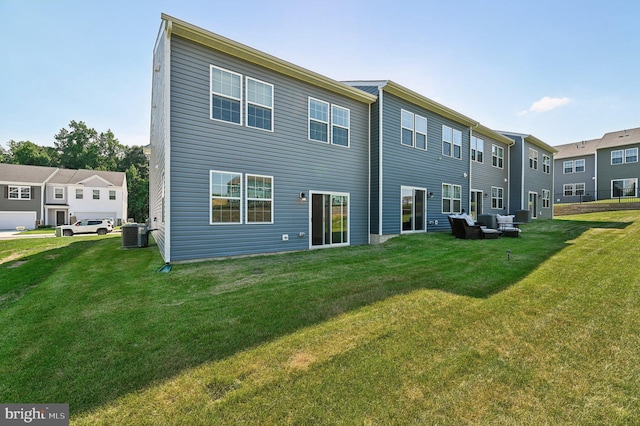 back of house with a lawn and central air condition unit