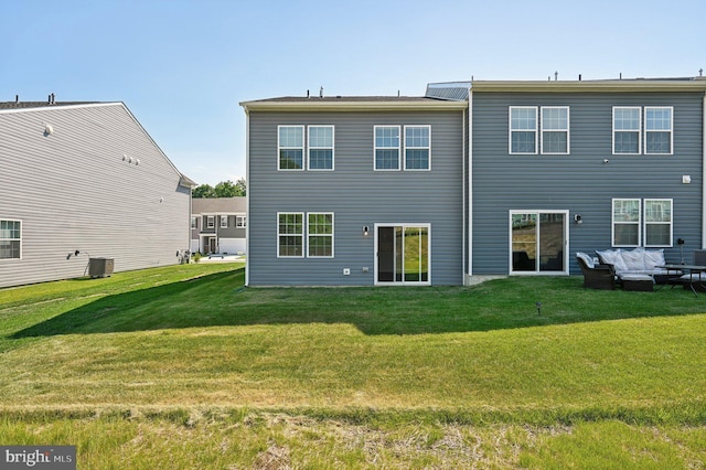 back of house featuring central AC unit and a yard