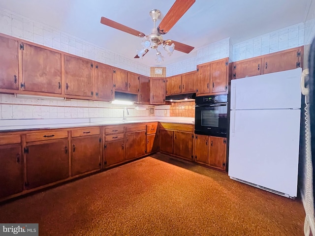 kitchen featuring ceiling fan, backsplash, white fridge, sink, and oven